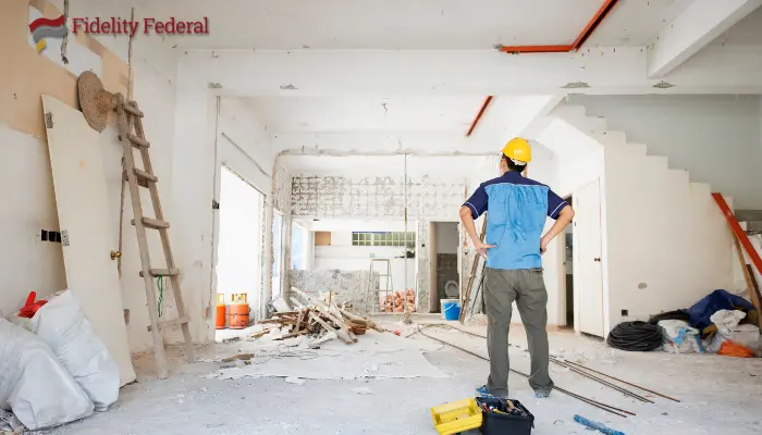 A man looking at a home that is under renovation. s